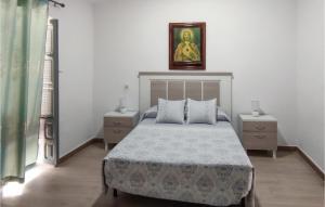 a bedroom with a bed and two night stands at Beautiful Home In Nerja With Wifi in Nerja +7 photos