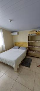 a bedroom with a bed in a room at Suíte o Pescador, praia do rosa in Garopaba +13 photos
