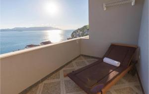 a bench sitting on a balcony overlooking the ocean at One-Bedroom Apartment Klek With Sea View 05 in Klek