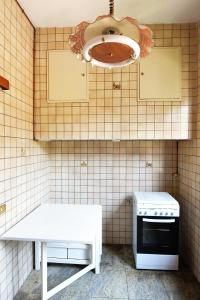 a kitchen with a white table and a stove at Appartamento a Perugia in Perugia +14 photos