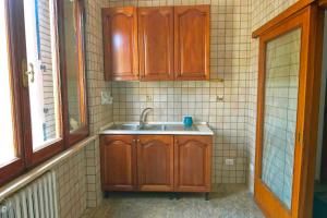 a kitchen with wooden cabinets and a sink at Appartamento a Perugia in Perugia