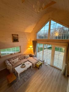a living room with a couch and a table at Relax House By The Stone in Nugariai