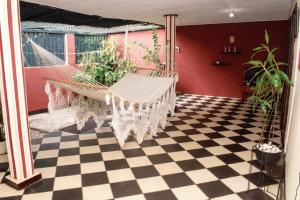 a hammock in a room with a checkered floor at Casa Rosa in Granada