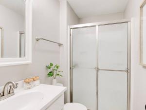 a bathroom with a shower and a toilet and a sink at Cozy 1-Bedroom Retreat, New Remodel, Fast Wi-Fi in Columbus +17 photos