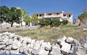 a house on a hill with a pile of rocks at Lovely Apartment In Kustici With Wifi in Kustići