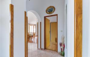 a hallway with an open door and a mirror at Lovely Apartment In Kustici With Wifi in Kustići