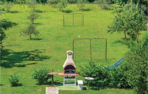 an outdoor grill in a field with a goal at Apartment Nedescina Brnjci in Santalezi +56 photos