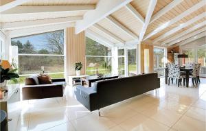 a living room with two couches and a table at Three-Bedroom Holiday Home In Sjallands Odde in Tjørneholm
