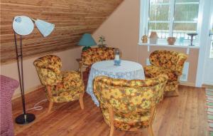 a room with a table and chairs and a lamp at Beautiful Home In Vilshult With Kitchen in Vilshult
