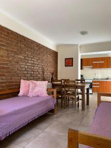 a bedroom with two beds and a brick wall at Complejo Pampa 1 in Santa Rosa