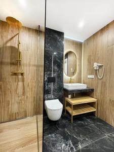 a bathroom with a toilet and a sink and a mirror at Domy pod Borczyną in Zwierzyniec +35 photos