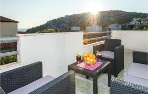 a balcony with a table with a bowl of fruit on it at Seahorse Apartments in Ražanj