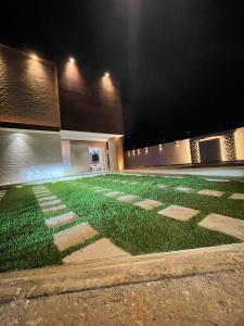 a field of grass in front of a building at night at Mansão Moraes - em Itacimirim Linha Verde in Camacari