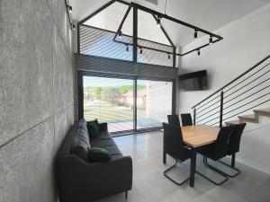 a living room with a couch and a table at Domy pod Borczyną in Zwierzyniec