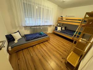 a room with two bunk beds and a ladder at Große Freiheit in Ellzee