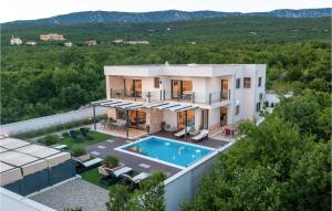 an aerial view of a house with a swimming pool at Villa Manali in Jadranovo +43 photos