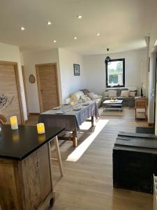 a living room with a table and a couch at Gites les Amourettes in Saint-Aubin-sur-Scie +6 photos