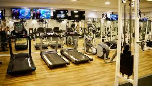 a gym with several treadmills and cardio machines at The MUSIC suite - Neot Golf Caesarea in Caesarea
