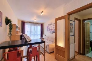 a living room with a dining room table and chairs at Apartamento la Folixa in Llanes