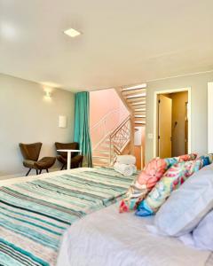 a bedroom with a bed and a staircase at Pousada Casa das Flores in Sao Jorge