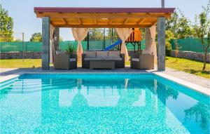 a pool with a gazebo and a pergola at Three-Bedroom Holiday Home In Vinjani Gornji in Aračići