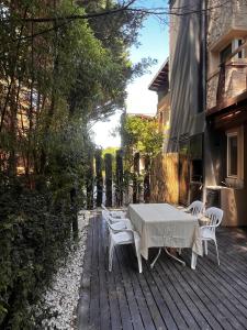 a table and chairs on a wooden deck at Bosque de Ciruelos in Carilo