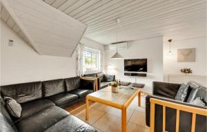 a living room with a couch and a table at Beautiful Home In Ulfborg With Sauna in Øby