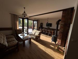 a living room with a couch and a wood stove at Hereczówka 2 in Bardo