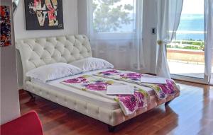 a large bed in a room with a large window at 4 Bedroom Gorgeous Home In Kostrena in Kostrena