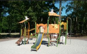 a playground in a park with a slide at Cocon avec spa in Mios