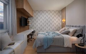 a bedroom with a bed and a tv on a wall at Villa Katarina Privlaka in Privlaka