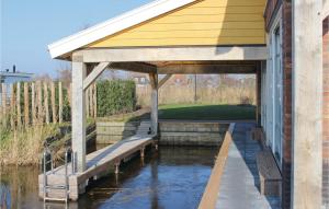 a building with a bench on the water at Bodelaeke-Schiphuis Wellness 8 in Giethoorn