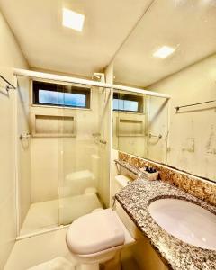 a bathroom with a toilet and a sink and a shower at Pousada Casa das Flores in Sao Jorge +54 photos