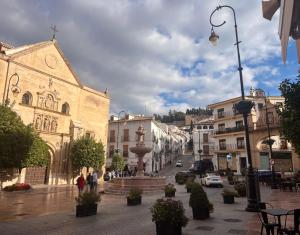 a town with a fountain in the middle of a street at Piso céntrico en zona monumental de Antequera in Antequera