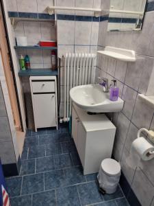 a small bathroom with a sink and a toilet at Isthmus Cuddly Nest in Isthmia +9 photos