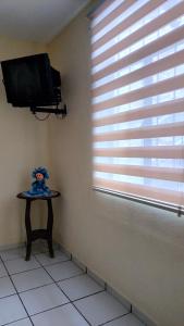 a corner of a room with a tv and a table at Hotel Chely in Bernal +126 photos
