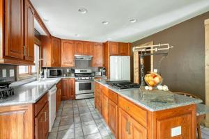 a kitchen with wooden cabinets and a counter top at Highland Farms - Your Private Forest Farm in Brightwood