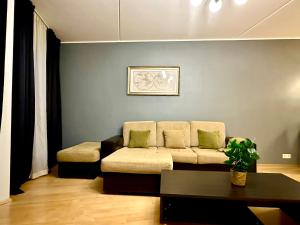 a living room with a couch and a table at Luxury Suites Rotermanni by Rikas Hotels in Tallinn