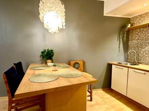 a kitchen with a wooden table with plates on it at Luxury Suites Rotermanni by Rikas Hotels in Tallinn +4 photos