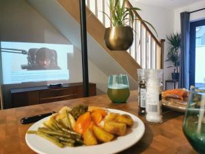 ein Teller mit Essen auf einem Tisch mit einem Glas Wein in der Unterkunft The Bath House & Sauna Garden x 4 beds in Newcastle + 27 Fotos