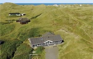an aerial view of a house on a grassy hill at Holiday Home Klægdalen Ringkøbing Denm in Halkær