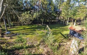 a yard with a house and trees and grass at Holiday Home Sletten Hadsund I in Helberskov