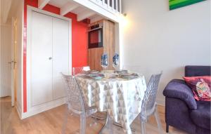 a dining room with a table and chairs at Beautiful Home In Montmartin-Sur-Mer in Montmartin-sur-Mer
