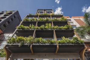 a building with plants on top of it at Golden Valley Hotel in Medellín