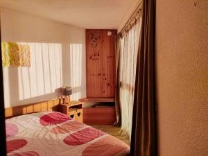 a bedroom with a bed and a window at F2 front de neige la Rosière in La Rosière