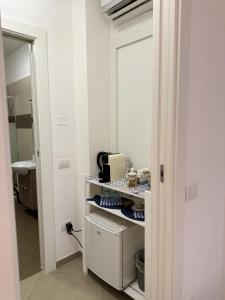 a bathroom with a sink and a shelf with food at Alba b&b in Polignano a Mare
