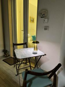a table and chairs in a room with a bedroom at Alba b&b in Polignano a Mare