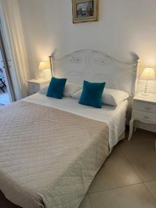 a bedroom with a white bed with blue pillows at Alba b&b in Polignano a Mare +36 photos