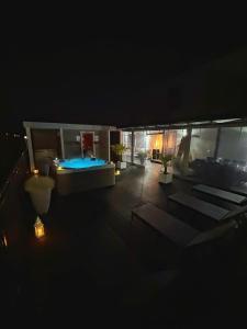 a night view of a patio with a swimming pool at Willa Agnieszka in Jastrzębia Góra