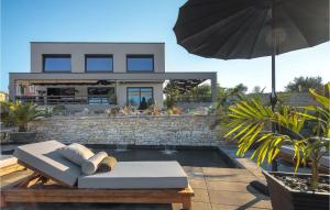 Cette maison dispose d'une terrasse avec un parasol. dans l'établissement Villa Merapi, à Sveti Lovreč Pazenatički